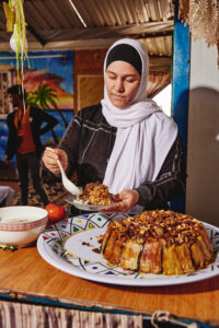 Woman in hijab serving pastry dessert