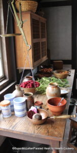 rustic table with pottery, fruit and vegetables